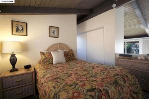 a bedroom with a bed and a lamp and a window at Stunning 2BD 2BA Ocean Front Condo Great View, AC in Wailuku
