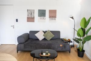 a living room with a couch and a table at The L Smart Suite - Premium & Minimal in Ierapetra