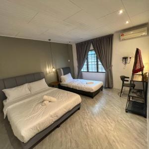 a hotel room with two beds and a ladder at A6886 Swimming Pool Villa in Kuantan +20 photos