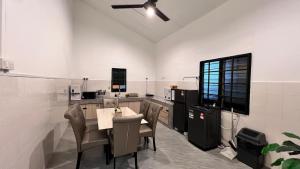 a kitchen with a table and chairs in a room at A6886 Swimming Pool Villa in Kuantan
