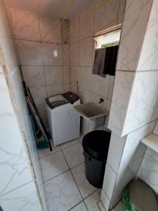 a small bathroom with a sink and a trash can at Apartamento Ryso do Mar Porto de Galinhas in Porto De Galinhas +7 photos
