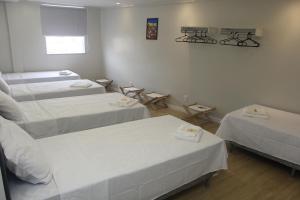 a hospital room with two beds and two tables at Centro de Formação in Belém