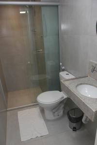 a bathroom with a toilet and a shower and a sink at Centro de Formação in Belém