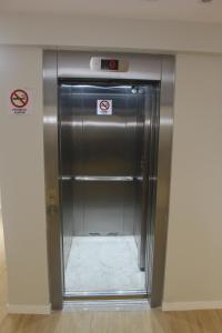 a elevator in a room with a metal door at Centro de Formação in Belém