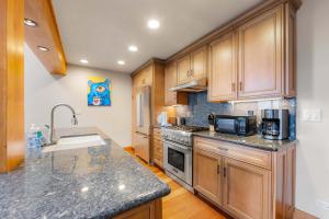 a kitchen with wooden cabinets and granite counter tops at Aspen Edge Lakefront and Loft in South Lake Tahoe +25 photos