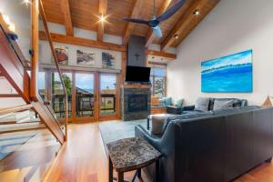 a living room with a couch and a fireplace at Aspen Edge Lakefront and Loft in South Lake Tahoe