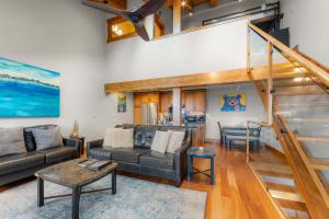 a living room with a couch and a table at Aspen Edge Lakefront and Loft in South Lake Tahoe