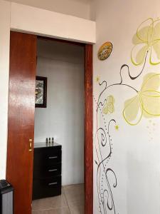 a hallway with a wall with butterfly decals at El Hogar de Carmelita in Guanajuato