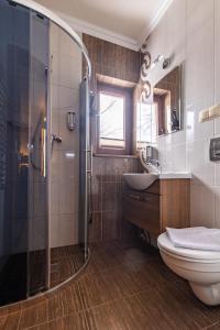 a bathroom with a shower and a toilet and a sink at Ostrysz in Dzianisz +55 photos