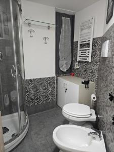 a bathroom with a shower and a toilet and a sink at Casa GiuBarElla in Vanzago +45 photos