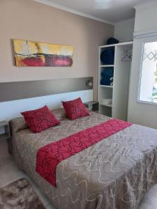 a bedroom with a bed with red pillows on it at Resort Termal Chajarí in Chajarí +16 photos