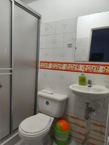 a bathroom with a toilet and a sink at Hotel Quinchia in Quinchía