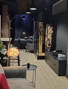 a living room with a couch and a table at KALI Old Town LOFT with Monument view in Bucharest