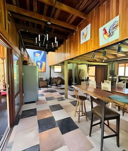 an open living room with a checkered floor at Refugio da Serra - Cachoeira dos Bufalos in Pindamonhangaba +34 photos