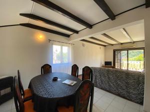 a dining room with a black table and chairs at Apartment Solara in Kampor