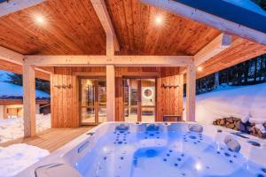 a jacuzzi tub in a wooden house at Luxury Chalet with Private Spa & Wellness Area in Megève
