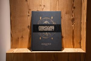 a book sitting on top of a wooden shelf at Luxury Chalet with Private Spa & Wellness Area in Megève