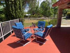 three chairs and a table on a patio at Casa los Churumbeles in Potrerillos