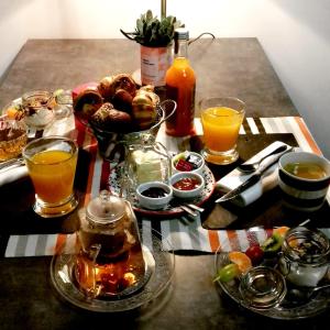 a table with a tray of food and drinks at B&B Côté Moulin in Jayat