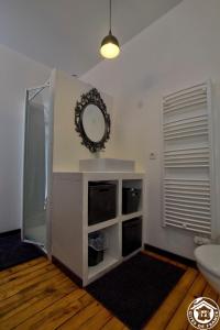 a room with a mirror on a counter with a toilet at B&B Côté Moulin in Jayat