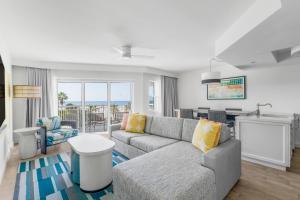 a living room with a couch and a table at Beach House Suites by the Don CeSar in St. Pete Beach