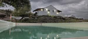 a house on a hill with a pool of water at Xaraba in Villa Parque Siquiman +13 photos