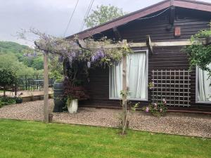 a house with a bunch of flowers in front of it at Roundstone View in Bewdley