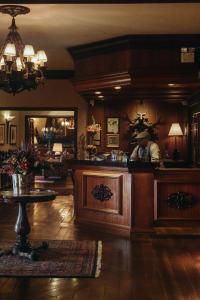 a man standing behind a bar in a room at Casa da Montanha in Gramado