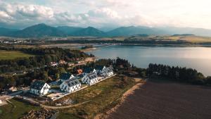 an aerial view of a large house next to a lake at Liptov Hills in Liptovský Mikuláš