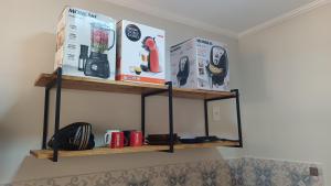 a shelf on a wall with books and books at Barreto Leme Studio 12 in Campinas