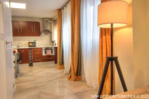 a kitchen with curtains and a lamp in a room at Triana Home centro ciudad in Murcia
