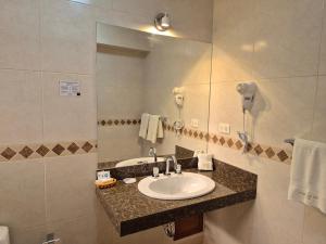 a bathroom with a sink and a mirror at Florida del Inca Hotel in Cusco +27 photos