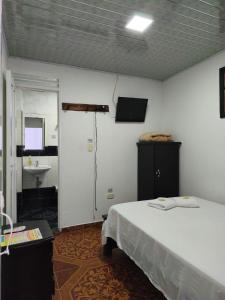 a bedroom with a bed and a bathroom with a sink at Hotel Quinchia in Quinchía +30 photos