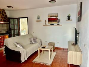 a living room with a couch and a table at Lupita's House in Punta Mujeres
