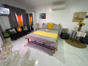 a bedroom with a bed and a living room at Royal Terrace Apto. II (Princess) in San Felipe de Puerto Plata +47 photos