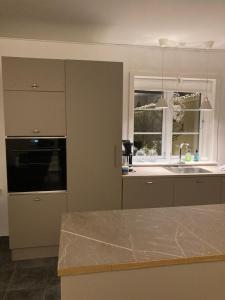 a kitchen with a counter top and a sink at Lykkebjerg in Varde