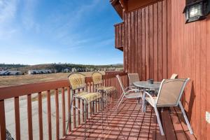 a patio with chairs and a table on a balcony at Soda Springs Ranch Unit 3C in Grand Lake