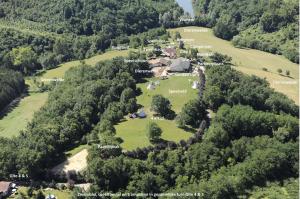 an aerial view of a house in a field with trees at camping roussel in Saint-Paul-dʼEspis