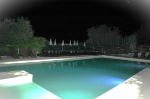 a large swimming pool at night with umbrellas at camping roussel in Saint-Paul-dʼEspis +10 photos