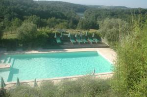 a swimming pool with lounge chairs and a view at camping roussel in Saint-Paul-dʼEspis