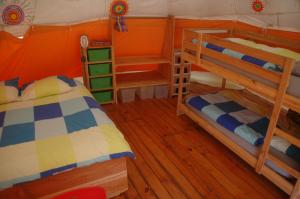 two bunk beds in a room with wooden floors at camping roussel in Saint-Paul-dʼEspis