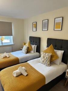 two beds sitting next to each other in a room at Mill House in West Bromwich
