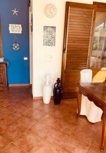 a dining room with a table and vases on the floor at Villa Verabetta in San Vito lo Capo +75 photos