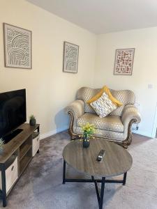a living room with a couch and a coffee table at Mill House in West Bromwich