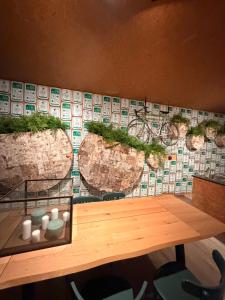 a table with some plants on a wall at Fiets Kot in Keerselaar
