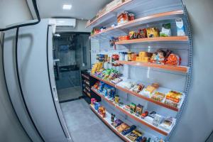 a refrigerator filled with lots of food at Zuccaro Studio in Bauru