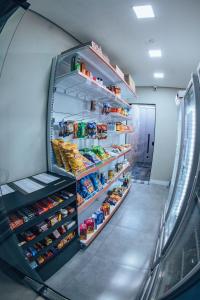 a refrigerator filled with lots of different types of food at Zuccaro Studio in Bauru