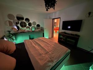 a bedroom with a bed and a flat screen tv at Wellnesshaus - Whirlpool - Sauna - Relax in Herten +2 photos