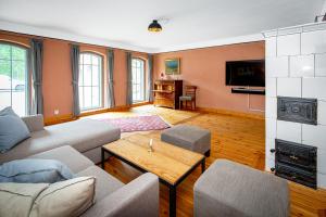a living room with a couch and a table at Feriengut Welzin in Welzin