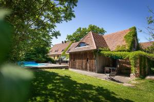 an exterior view of a house with a pool at Feriengut Welzin in Welzin